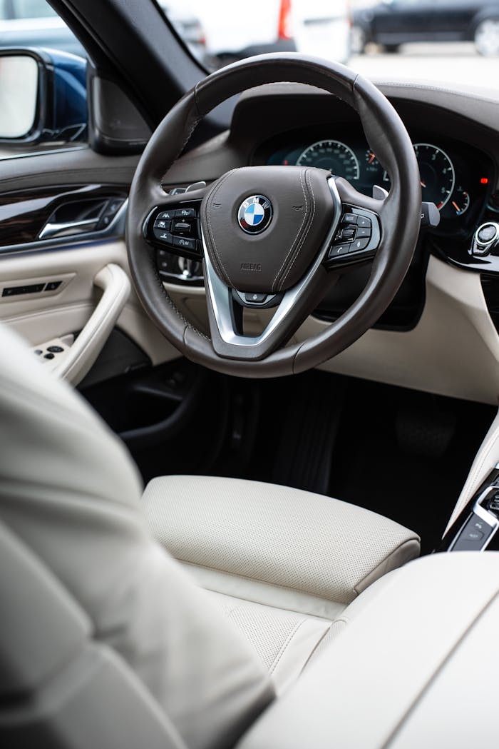 Explore the premium interior of a luxury BMW featuring elegant white leather seats and modern design.